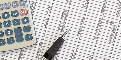 calculator, pen, and spreadsheet